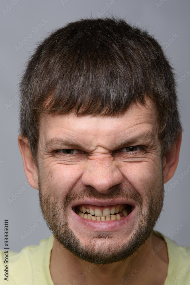 Closeup portrait of a madly evil man of European appearance Closeup portrait of a madly evil man of European appearance