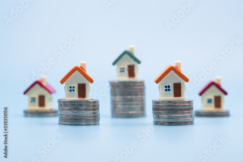miniature houses among pile of coins, Housing industry mortgage plan and residential tax saving strategy, mortgage, investment, real estate and property concept