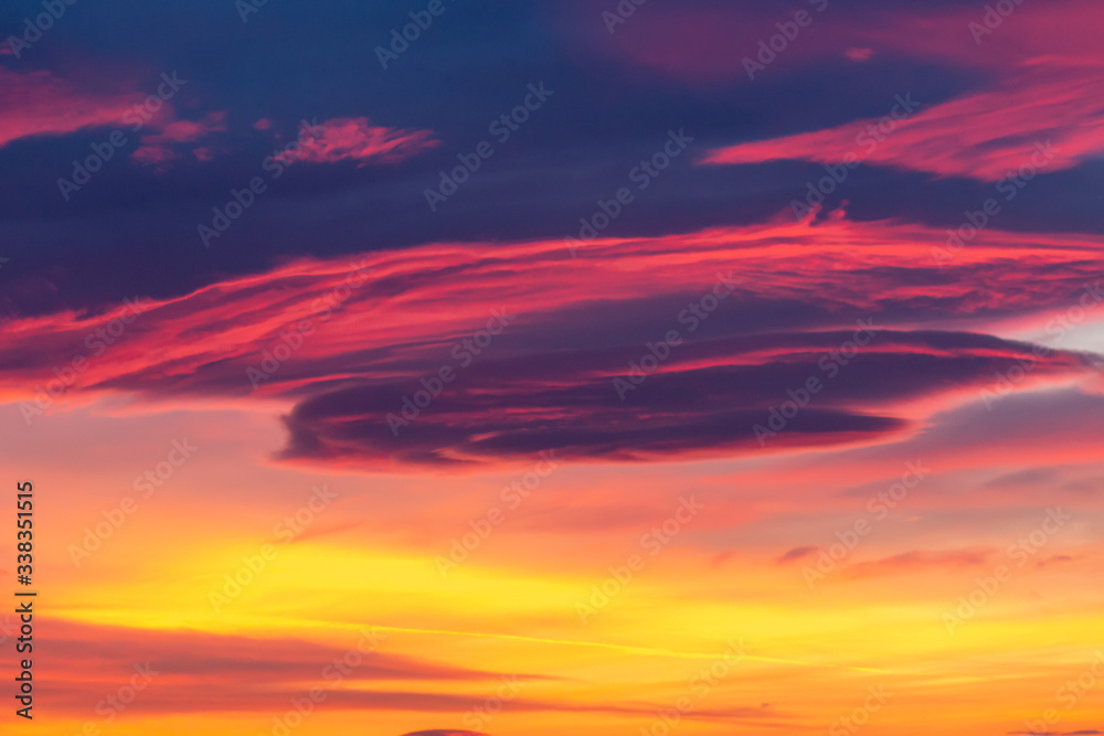 Dramatic sky background in purple, pink and orange hues. Abstract natural sunset skies skyscape, peaceful scenery in vivid colors, horizontal shot