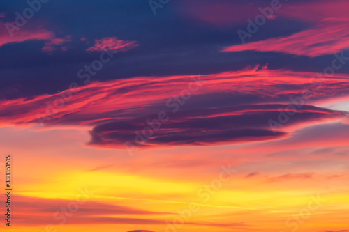 Dramatic sky background in purple, pink and orange hues. Abstract natural sunset skies skyscape, peaceful scenery in vivid colors, horizontal shot