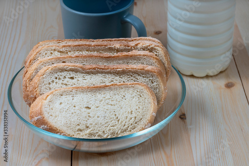 slices of white round wheat bread in a glass bowl on the kitchen table