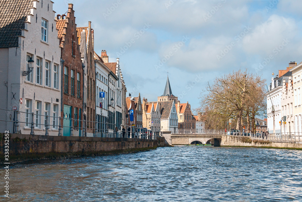 view of beautiful medieval houses on the stone promenade of the old Belgian city of Bruges