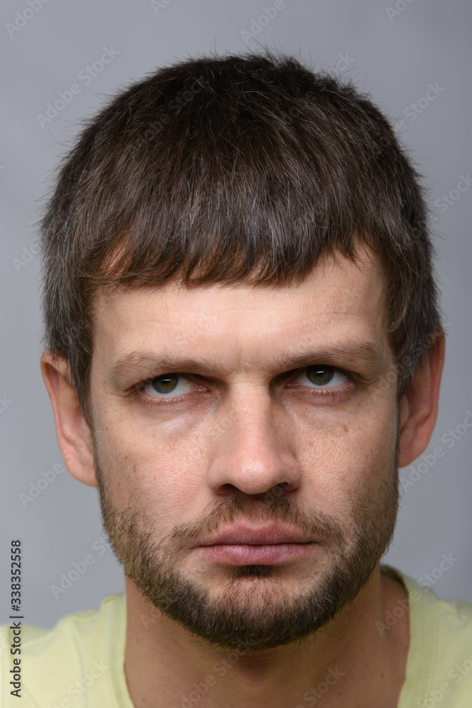 Close-up portrait of a gloomy tired man of European appearance Close-up portrait of a gloomy tired man of European appearance