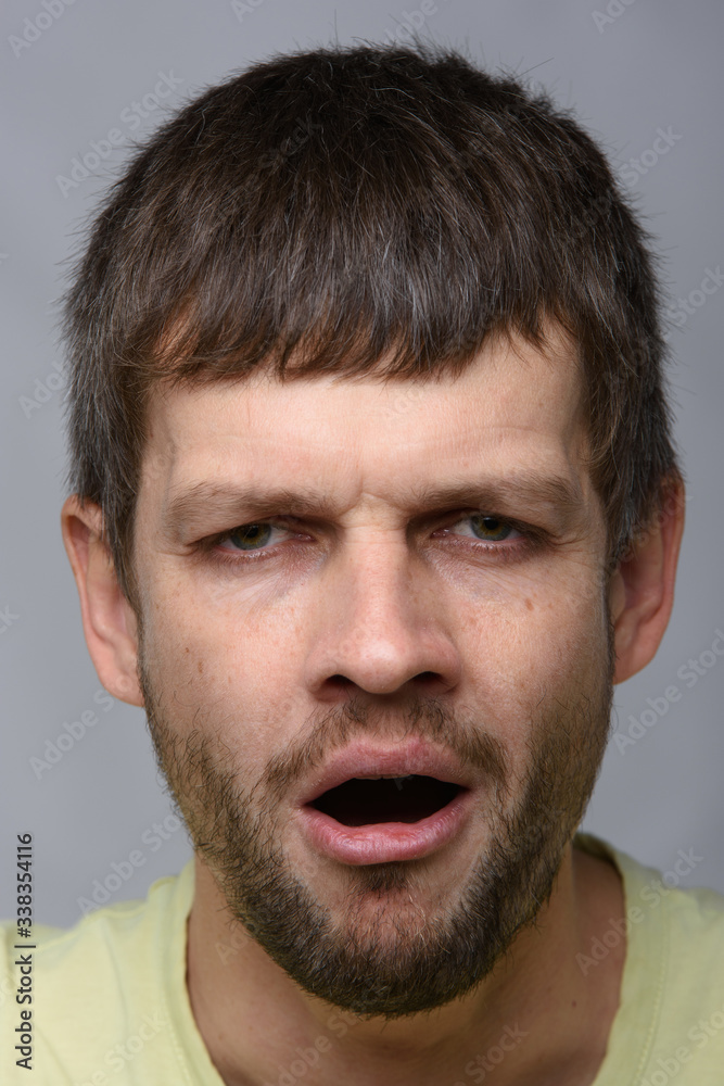 Obraz premium Closeup portrait of a tired yawning man of European appearance