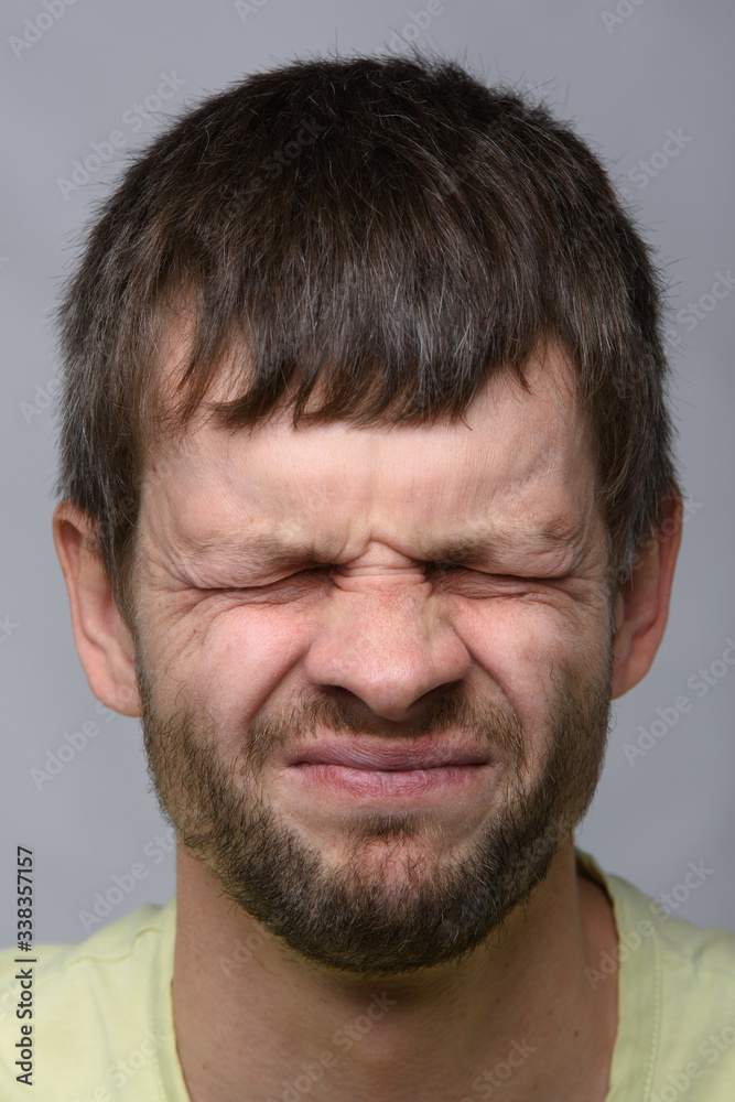 Close-up portrait of a squinted eye of a man of European appearance Close-up portrait of a squinted eye of a man of European appearance