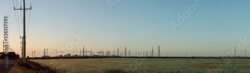 panorama of a large electrical power plant on the horizon against a colorful sunset sky on the outskirts of Melbourne city, Victoria, Australia