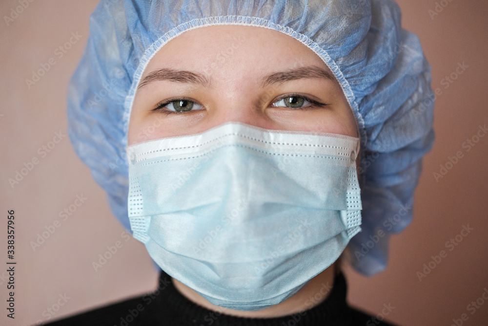 Asian woman in a protective face mask. Portrait of a young woman in a medical mask against covid-19 Asian woman in a protective face mask. Portrait of a young woman in a medical mask against covid-19