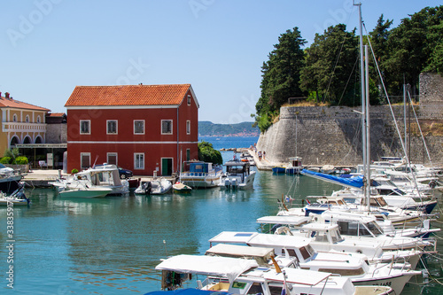 Zadar, Croatia; 07/17/2019: Lucica Fosa (Zadar harbour) full of boats and walls of the city in the old town of Zadar