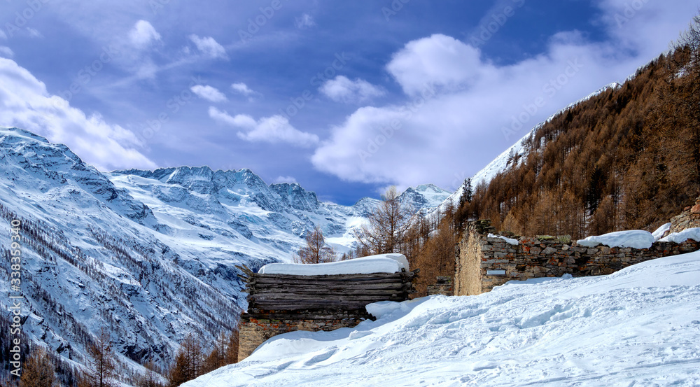 huts abandoned on a cold winter morning with Gran Paradiso in the background