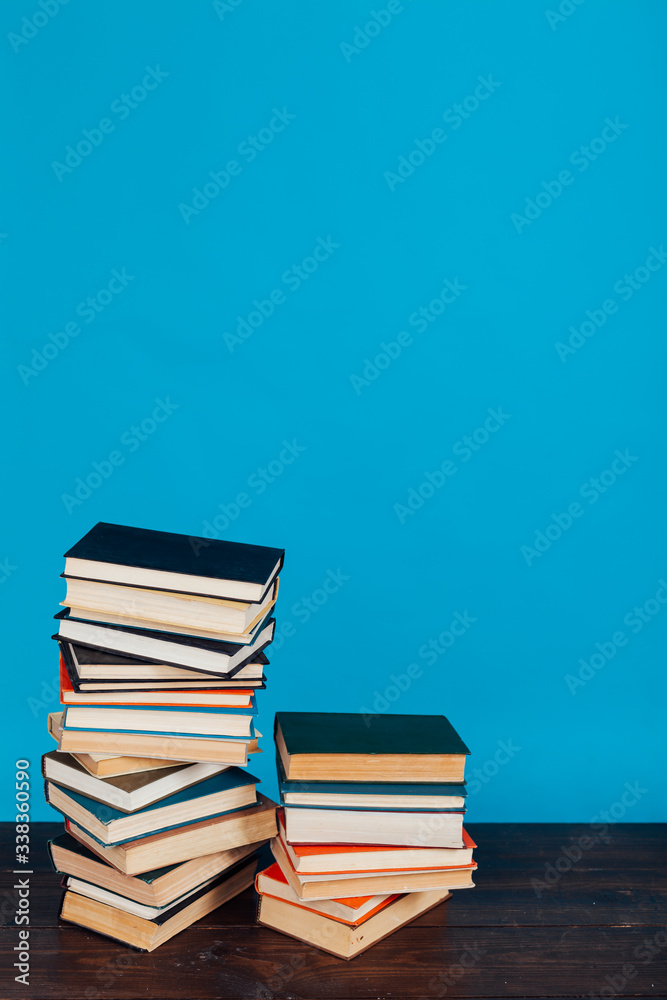 many stacks of educational books to teach in the library on a blue background many stacks of educational books to teach in the library on a blue background