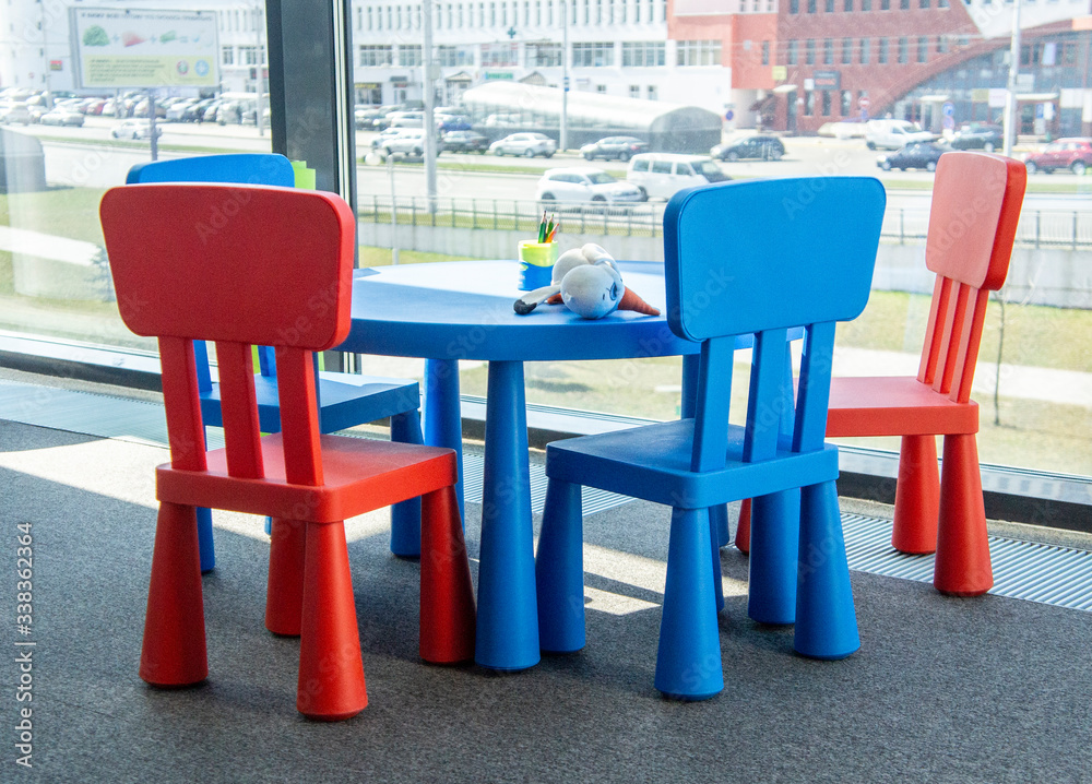 Colorful furniture chairs for children in a modern office near the window. Moscow, Russia - April 14 2020