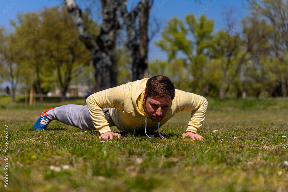 Man exercising in park. Fitness and relaxation in nature Man exercising in park. Fitness and relaxation in nature