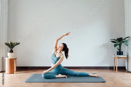 Obraz young asian beauty woman doing yoga at home