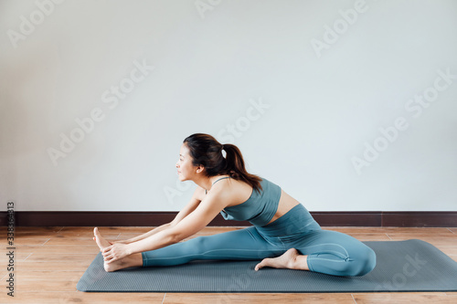 young asian beauty woman doing yoga at home