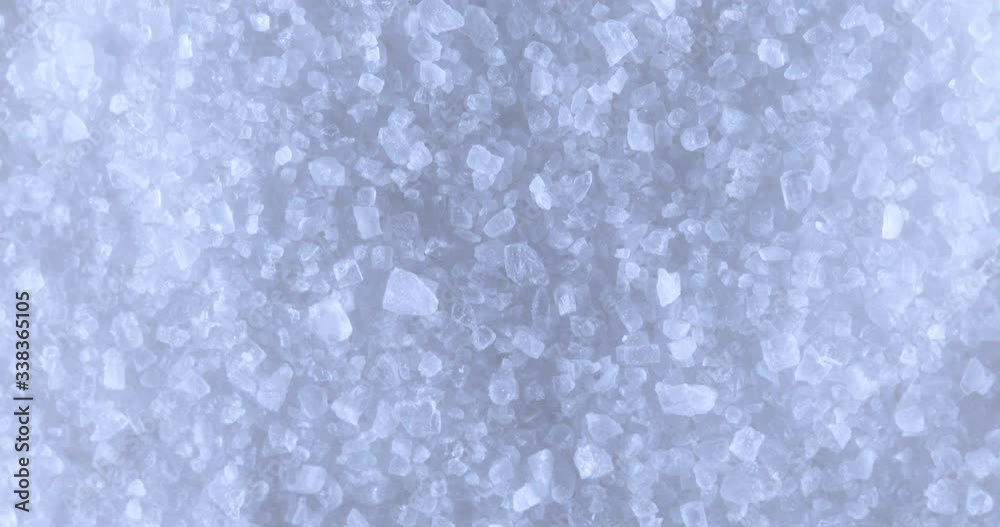 Sea salt grain crystals. Close up. Rotation