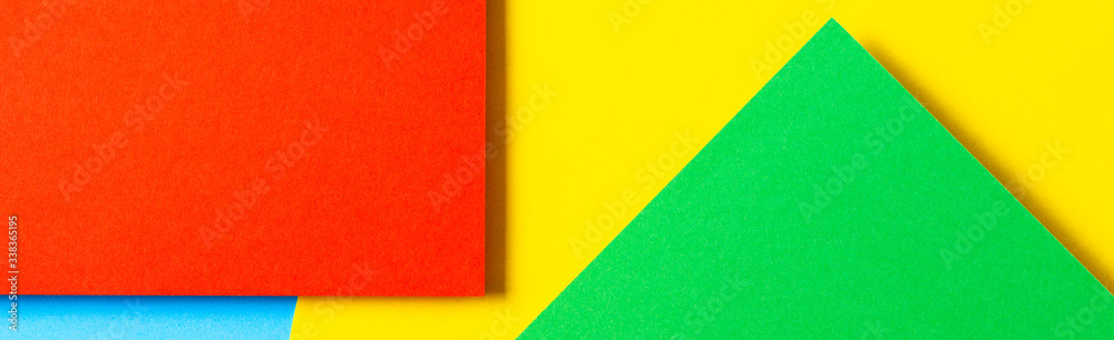 Fototapeta premium Abstract colored paper texture background. Minimal geometric shapes and lines in yellow, light blue, red, green colors