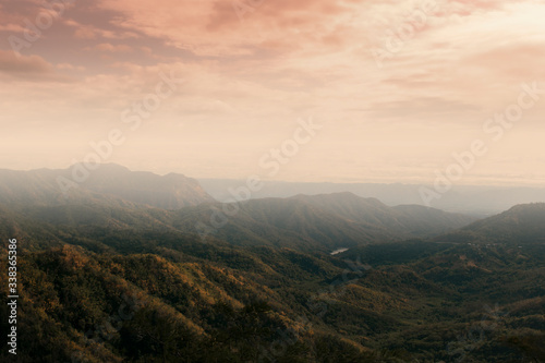 Forests in Thailand. Mist and fog on mountains in the morning and warm sunlight creates highlight and shadow. with haze and smoke effect. 