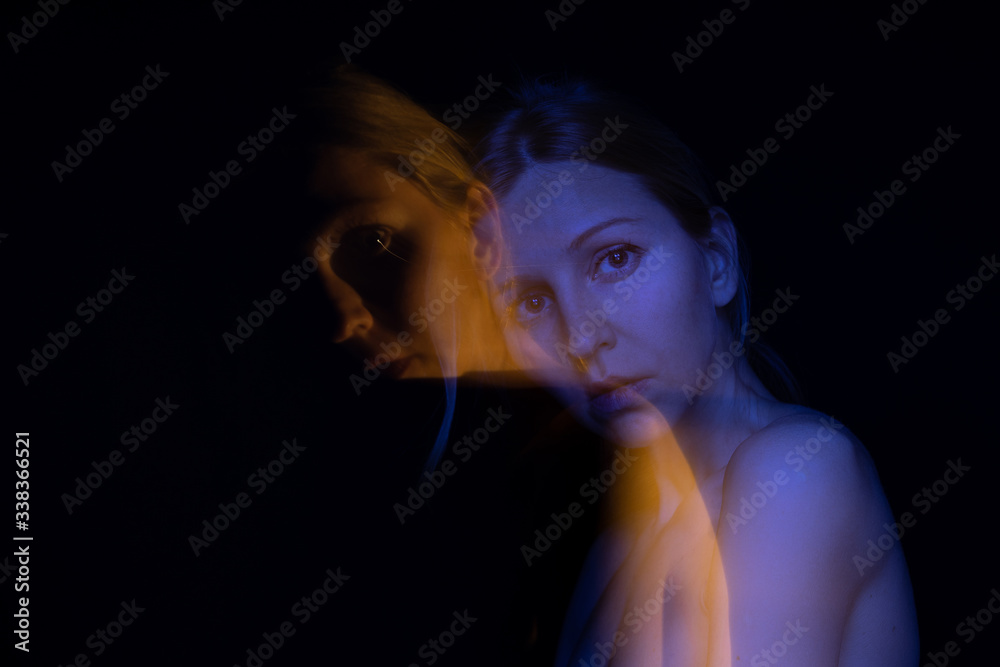 Sensible double portrait of young slim woman looking to the camera. Black background. Emotions and feelings.   psychological subconscious anxiety therapy theme. Creative long exposure series photos