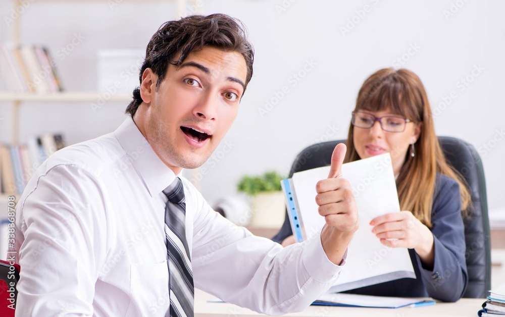 Man and woman discussing in office Man and woman discussing in office