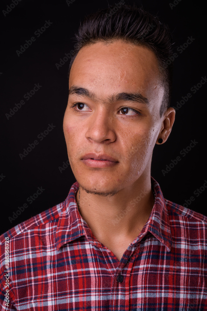 Obraz premium Face of young handsome Indian hipster man