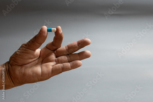 Hand and medicine Antiretroviral drug concept.