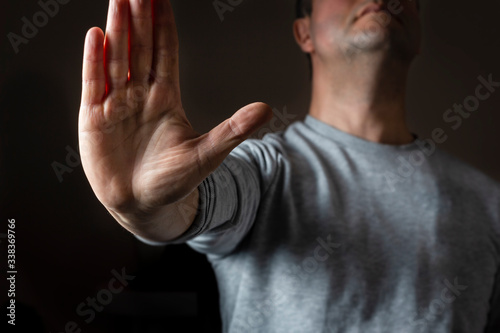 man showing stop sign with his hand