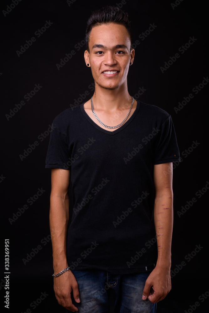 Portrait of happy young handsome Indian man smiling Portrait of happy young handsome Indian man smiling