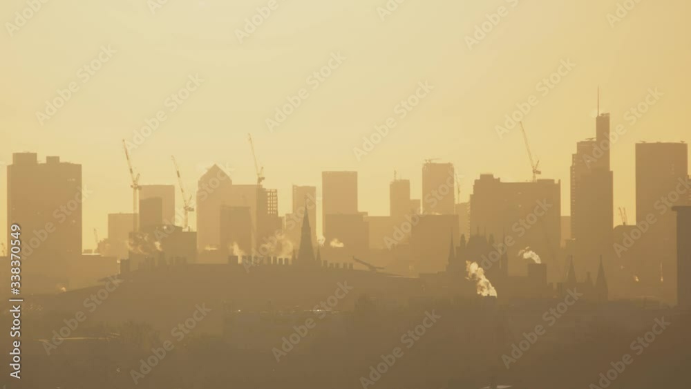 Hazey sunrise over London with pollution smog in the air. Hazey sunrise over London with pollution smog in the air.