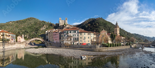 Dolceacqua, Italy. Panorama of the town with romanesque bridge (Ponte Vecchio), over the Nervia river and ruins of medieval castle