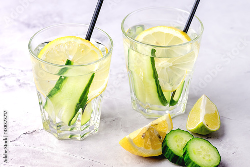 Glasses of Healthy Detox Water with Lemon and Cucumbers Diet Drink Straw Horizontal Above