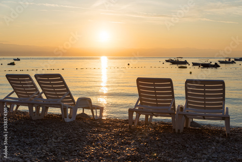 empty sunbed chairs at gravel beach moscenicka draga croatia, sunrise scenery © SusaZoom