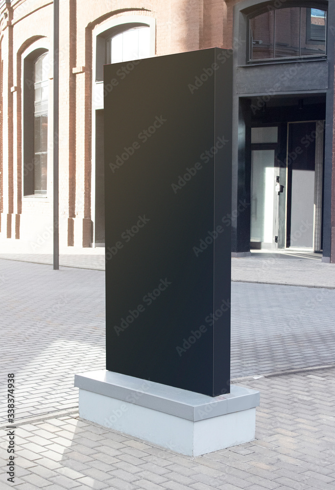 Blank black vertical pylon stand mockup brick building, side view Stock ...