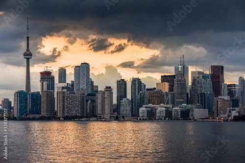 Toronto skyline buildings in the background, with the sea in the foreground, on a cloudy sunset. Toronto, Ontario, Canada © dhvstockphoto