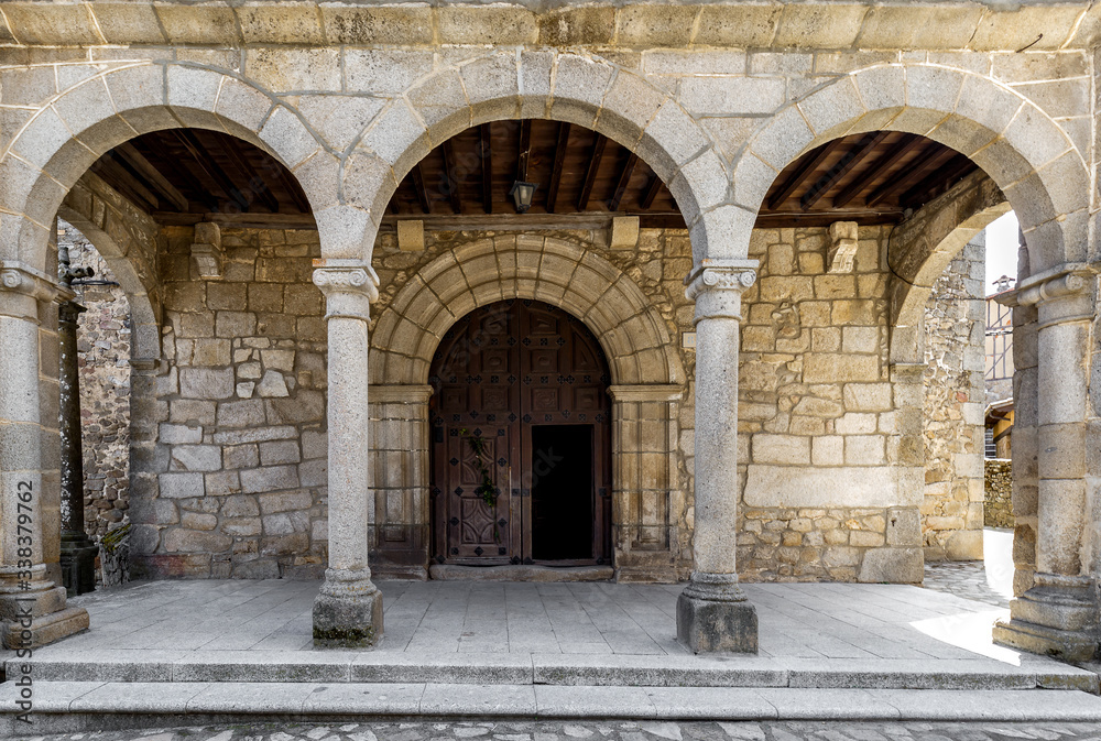 Entrance door and main facade of ancient church in San Martín del Castañar. Sierra de Bejar. Salamanca. Spain. UNESCO World Heritage site.