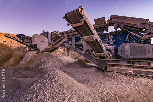 Excavator collecting stone in an open-cast mine