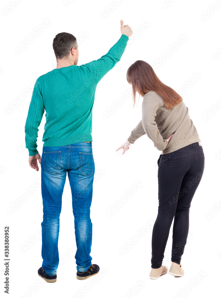 Back view of couple in sweater showing thumbs up.
