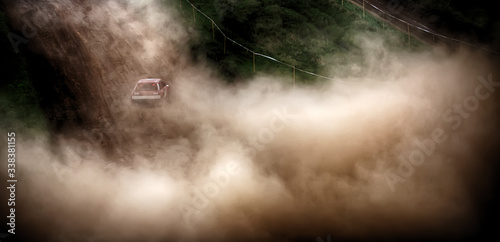 Racing sports car in dust clubs on the track , rally
