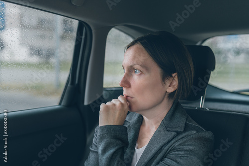 Worried businesswoman sitting at car back seat © Bits and Splits