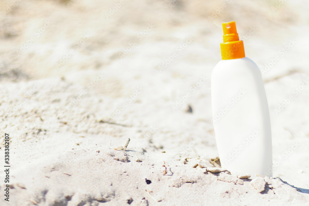 Mock up for sun protection cream on wild tropical beach with natural sand. White sunscreen bottle. Summer, vacation, travel concept. Copy space. Mock up for sun protection cream on wild tropical beach with natural sand. White sunscreen bottle. Summer, vacation, travel concept. Copy space.
