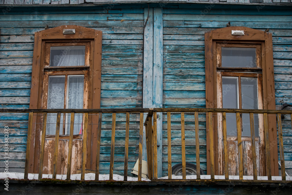 dilapidated housing, resettlement house on the background of a new house under construction