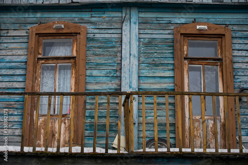 dilapidated housing  resettlement house on the background of a new house under construction