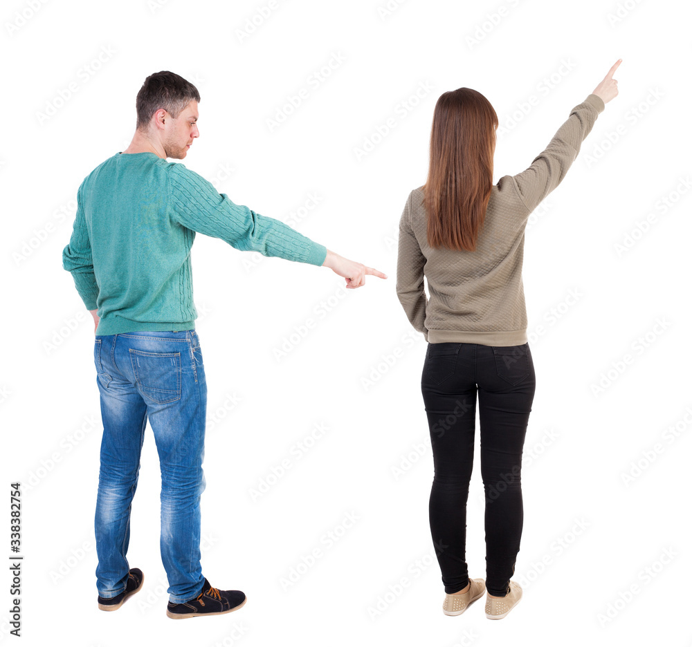 Back view of couple in sweater pointing. Back view of couple in sweater pointing.