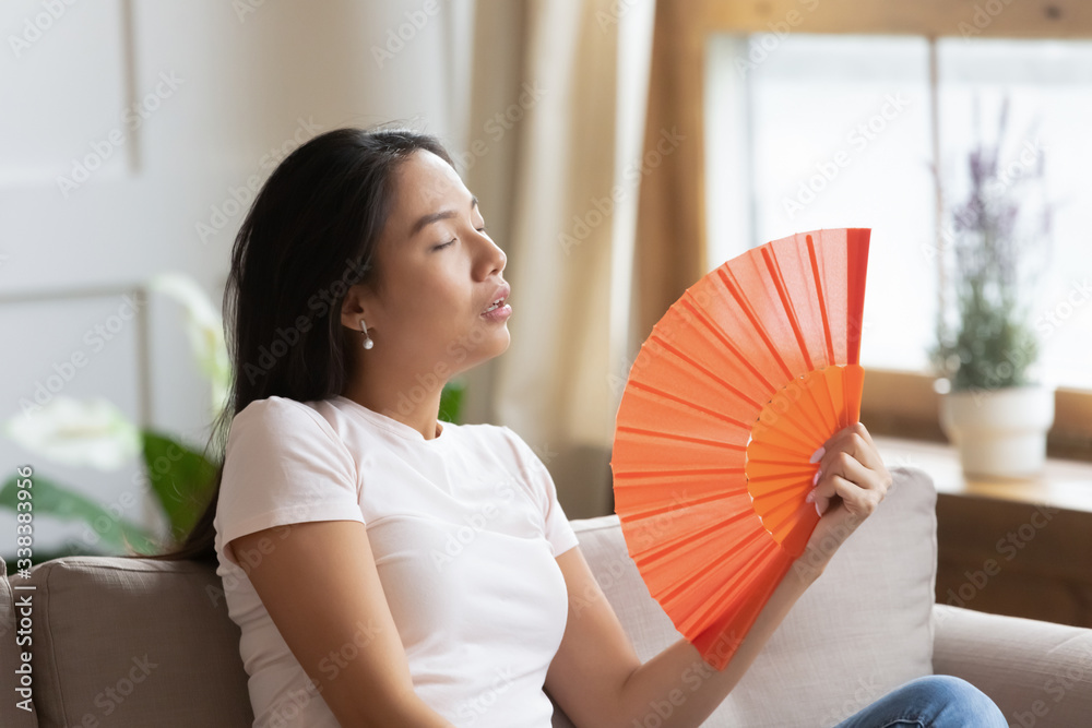 Premium Photo  Woman tired sweltering cooling with electric fan