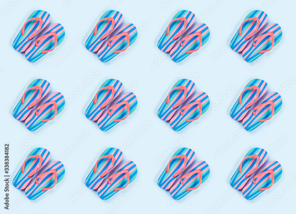 Obraz premium Summer colorful flip flop pattern on blue background. Beach vacation concept
