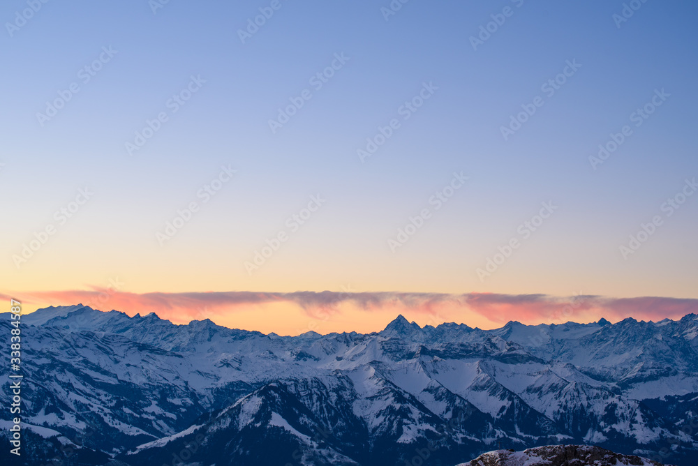 Colorful clouds above a mountain range in the Swiss Alps