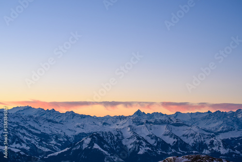 Colorful clouds above a mountain range in the Swiss Alps