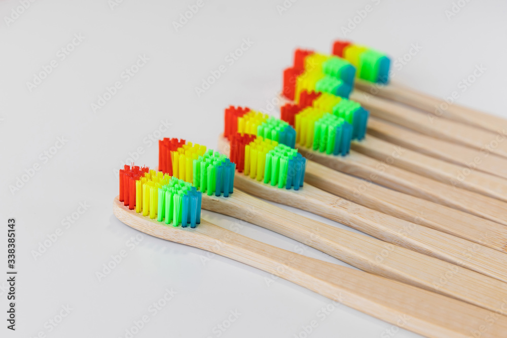 Pride concept. Rainbow bamboo toothbrushes. White background. Close-up, soft focus, copy space. Top view. Natural organic product for oral hygiene. Dental zero waste and no plastic concept. Safe earth Pride concept. Rainbow bamboo toothbrushes. White background. Close-up, soft focus, copy space. Top view. Natural organic product for oral hygiene. Dental zero waste and no plastic concept. Safe earth