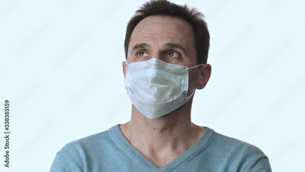 Man nervously looks around, in face mask to protect against virus and infections Man nervously looks around, in face mask to protect against virus and infections