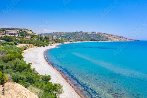 Cyprus. Beach at Pissouri. View of the Cyprus beach from the drone. Village of Pissouri. Resorts at the foot of mountain. Sand beach. Blue loguna of the Mediterranean Sea. Cruises to island of Cyprus
