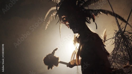 silhouette of a shaman dancing a ritual dance photo